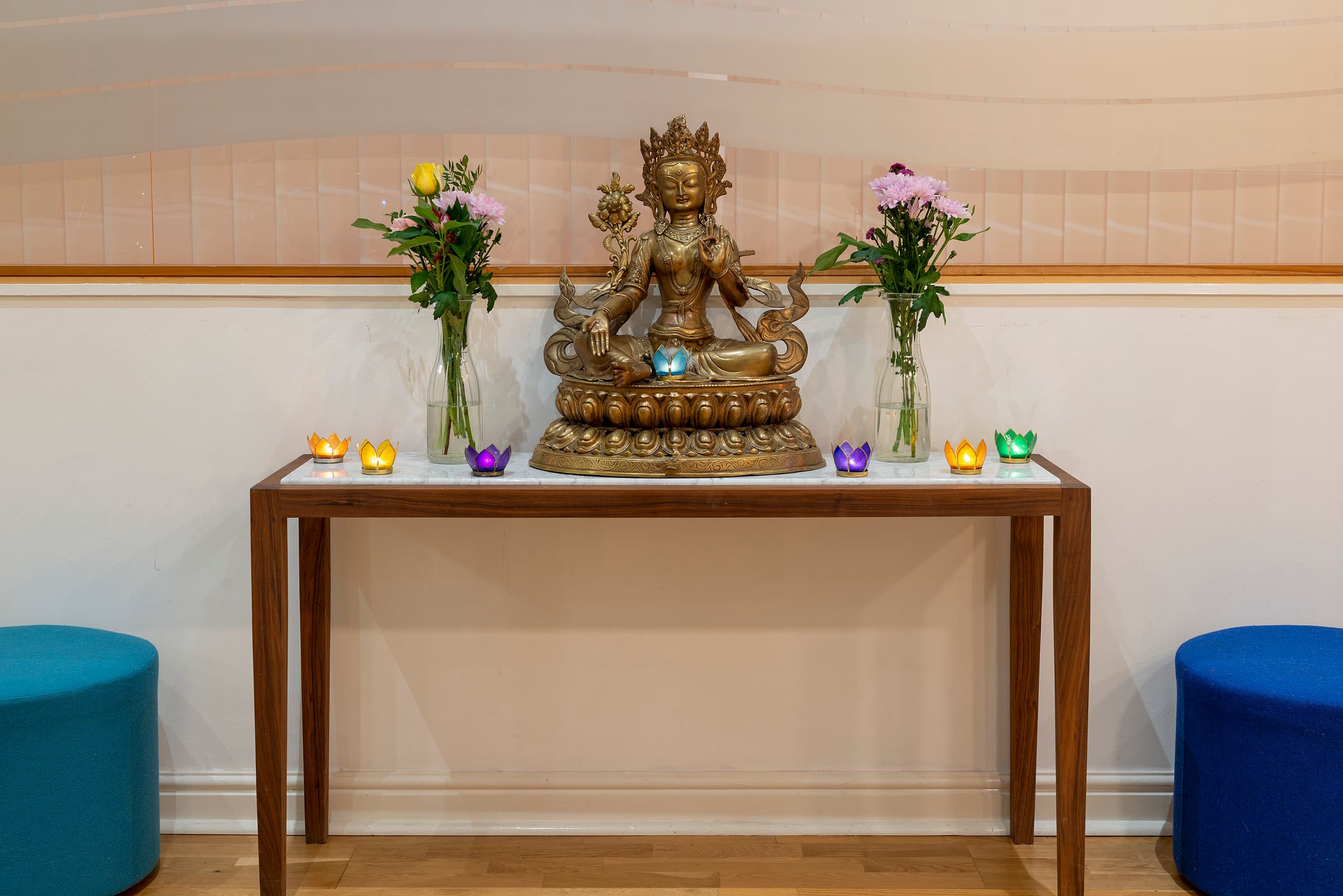 Tara statue with flowers and candles