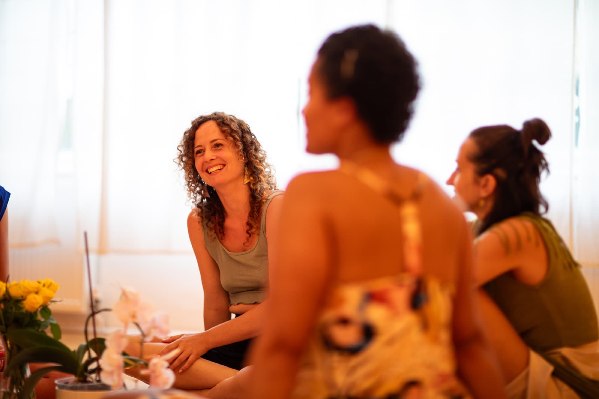 A woman laughing in the Shakti circle
