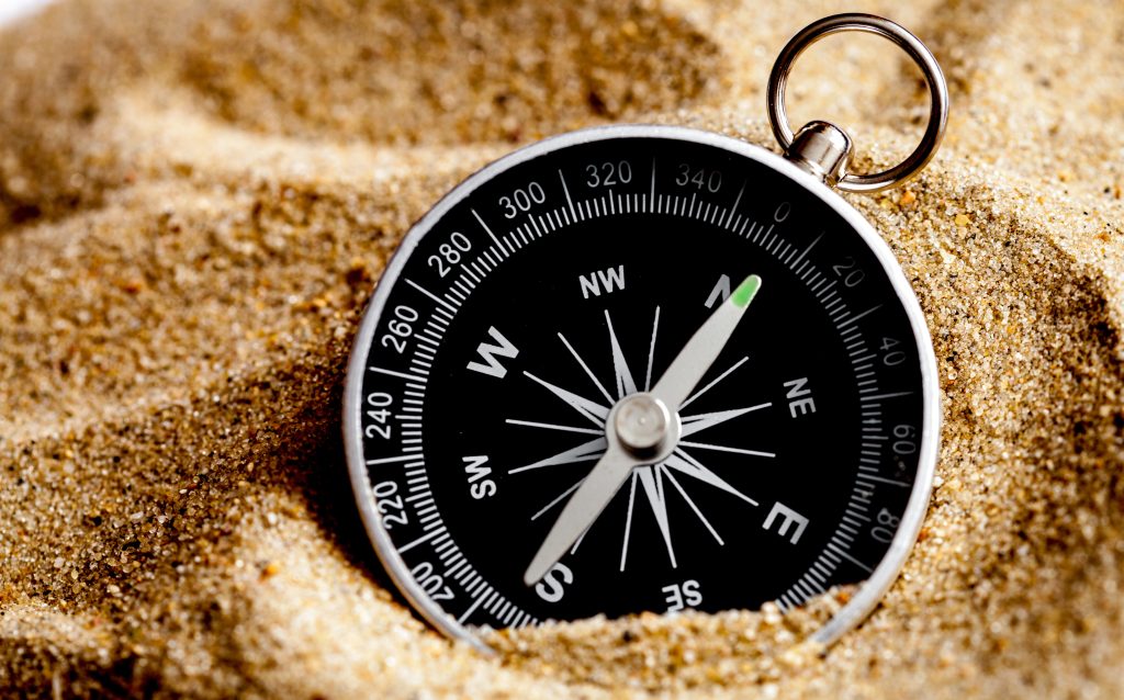 concept compass in sand searching meaning of life close up
